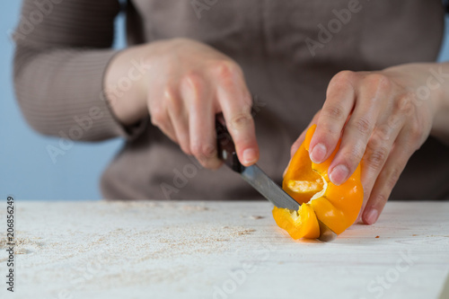 cook cuts with a sharp knife sweet yellow bell pepper