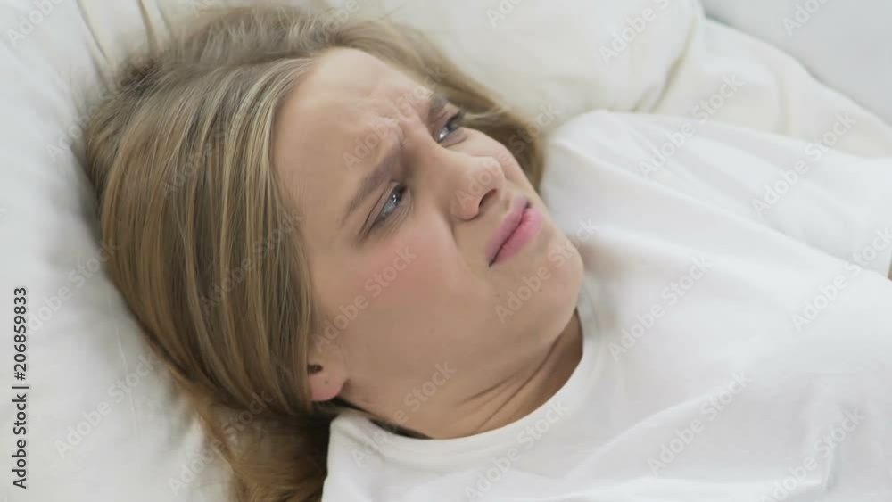 Student girl angry about noisy neighbors, trying to sleep more time in morning Student girl angry about noisy neighbors, trying to sleep more time in morning