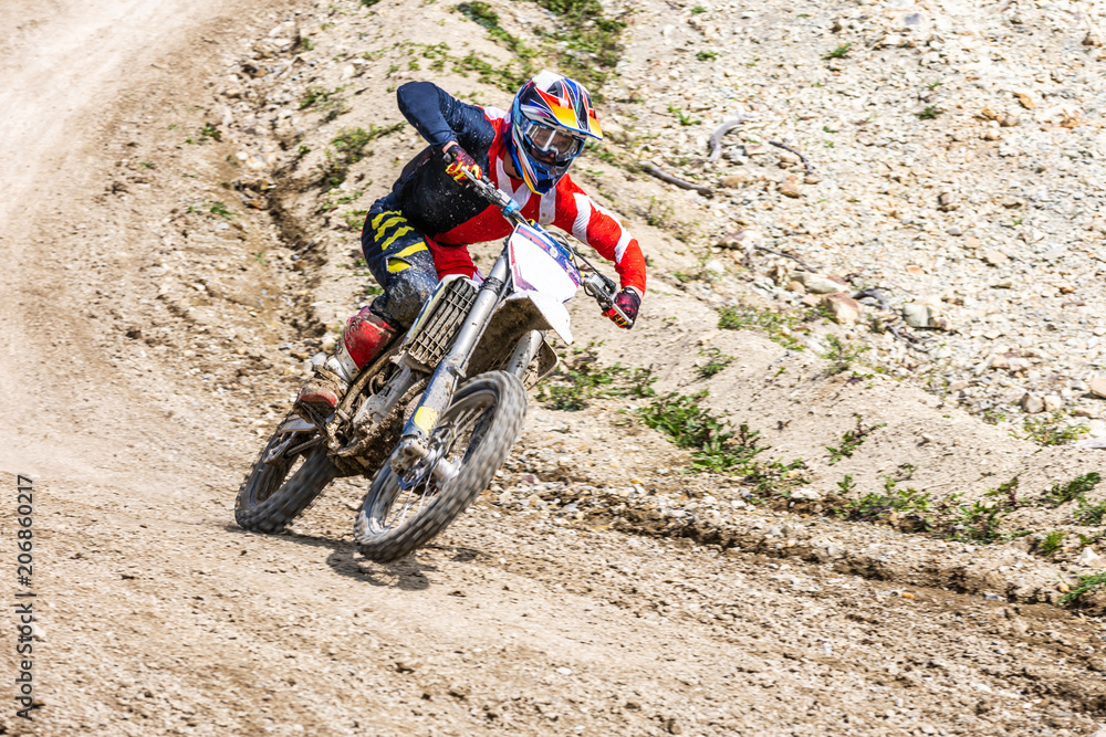 Professional Motocross Motorcycle Rider Drives Over the Road Track. Professional Motocross Motorcycle Rider Drives Over the Road Track.