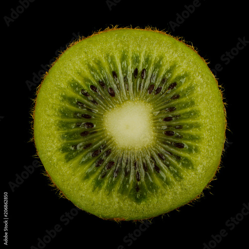 half of kiwifruit (kiwi) isolated on black background. front view