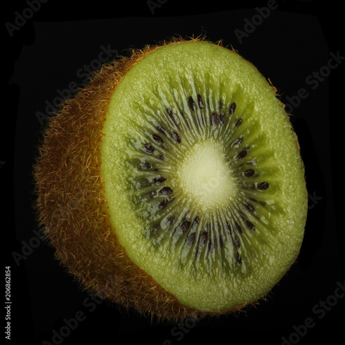 half of kiwifruit (kiwi) isolated on black background