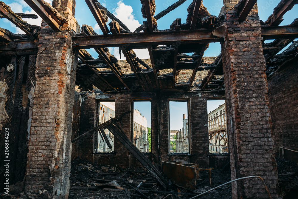 Burned and ruined house interior after fire, consequences of fire disaster accident Burned and ruined house interior after fire, consequences of fire disaster accident