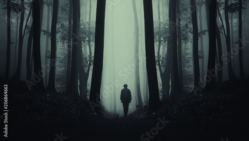 man on dark scary forest road, surreal landscape photo
