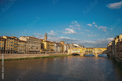 Overview of the river Arno, buildings and the Ponte Vecchio (bridge) at sunset. In the city of Florence, the famous and amazing capital of the Italian Renaissance. Located in the Tuscany region