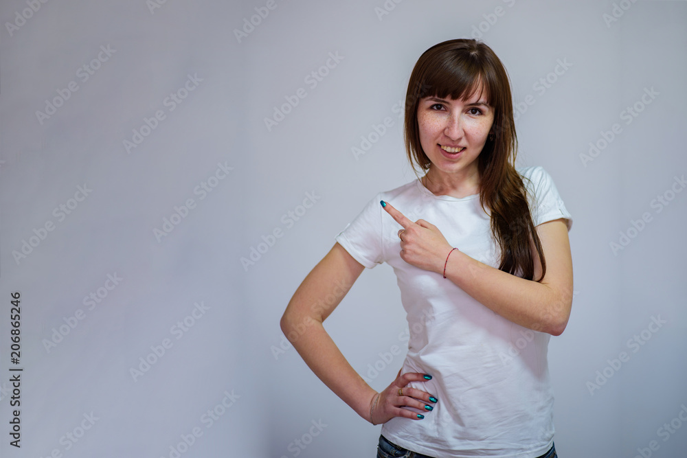 Portrait of beautiful brunette girl on white background showing on product. Portrait of beautiful brunette girl on white background showing on product.