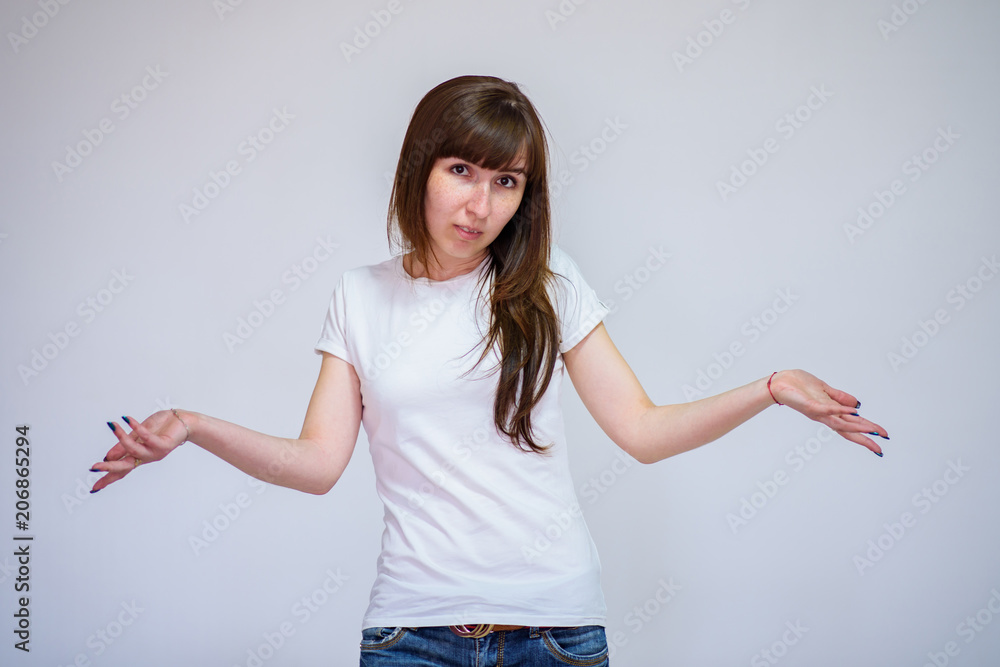 portrait of a beautiful brunette girl on a white background in different poses showing different emotions. portrait of a beautiful brunette girl on a white background in different poses showing different emotions.