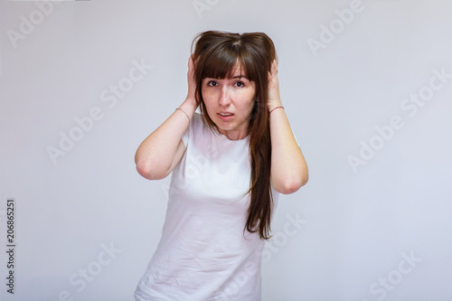 portrait of a beautiful brunette girl on a white background in different poses showing different emotions. photo