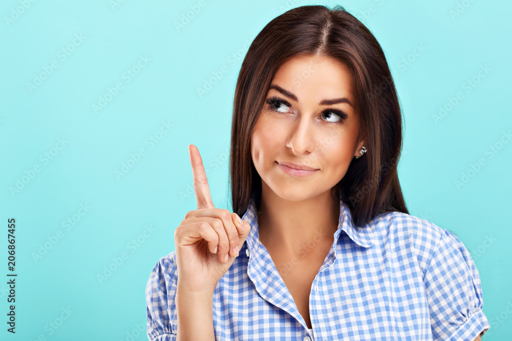 Woman against blue wall background Woman against blue wall background
