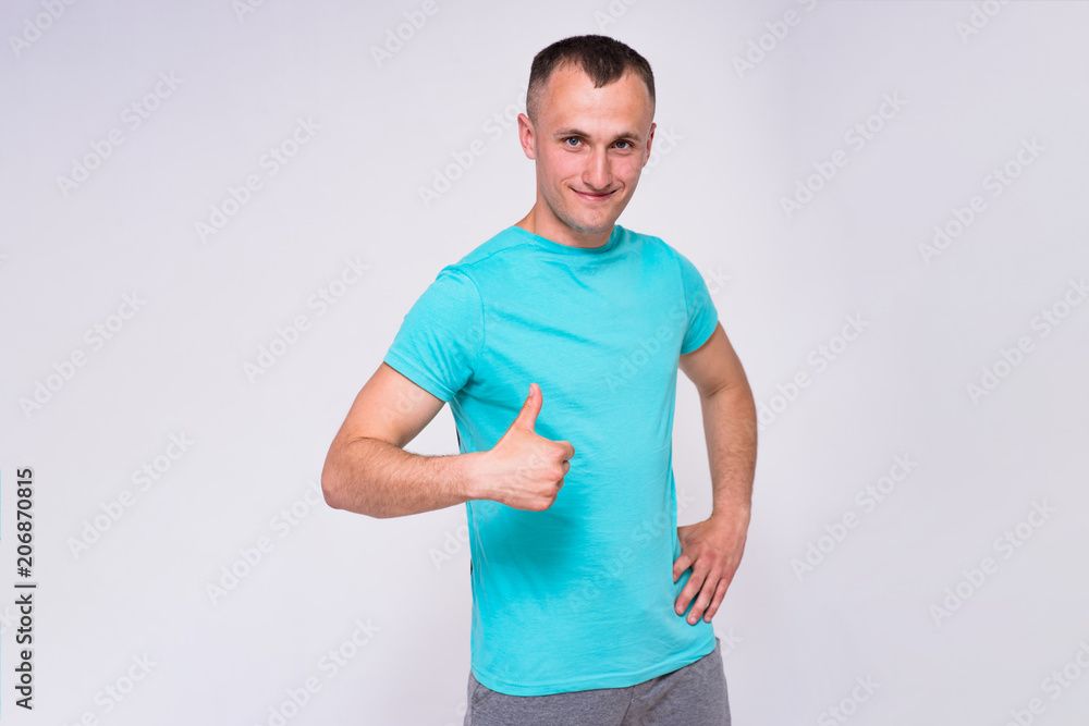 portrait of a handsome young man in a T-shirt on a white background in different poses showing in different emotions. portrait of a handsome young man in a T-shirt on a white background in different poses showing in different emotions.