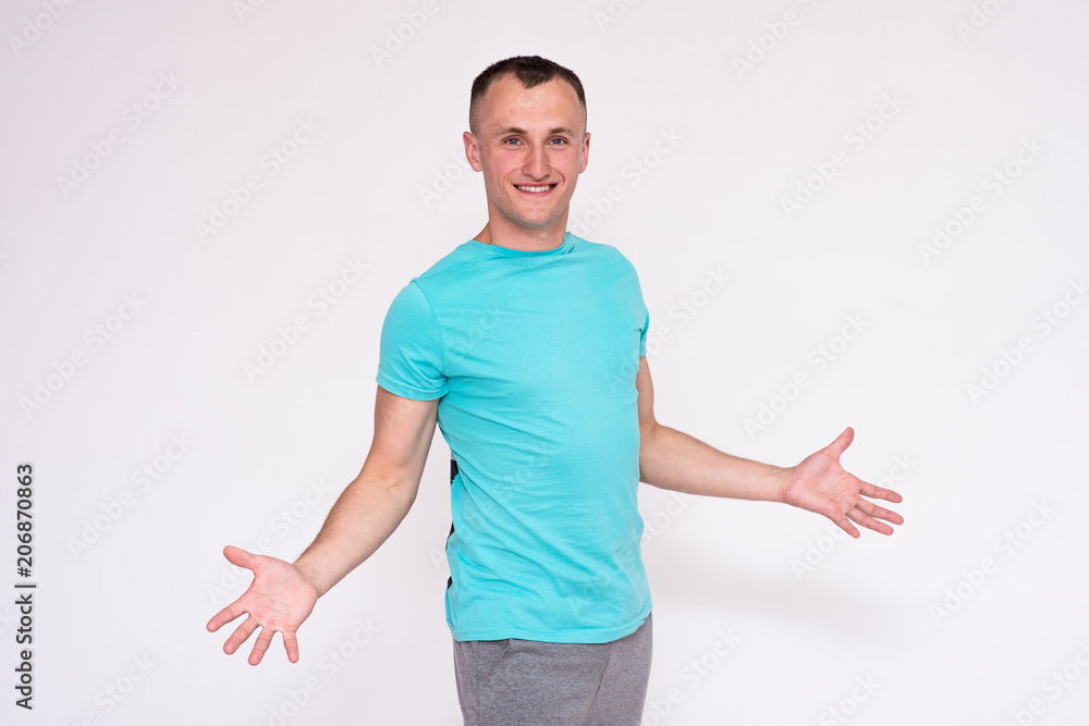 portrait of a handsome young man in a T-shirt on a white background in different poses showing in different emotions. portrait of a handsome young man in a T-shirt on a white background in different poses showing in different emotions.