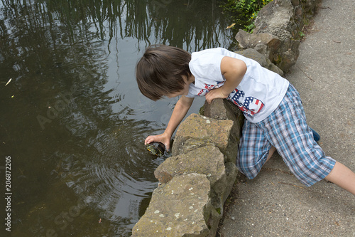 enjoy in summer, happy boy catching the turtle