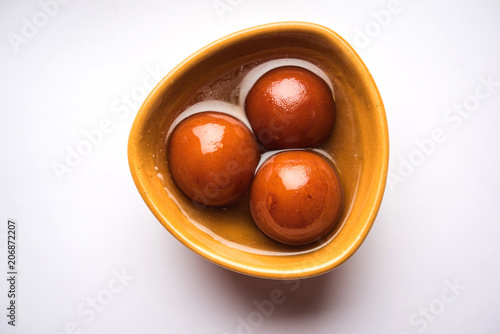 Sweet Gulab Jamun in terracotta bowl photo