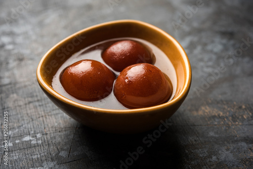 Sweet Gulab Jamun in terracotta bowl photo