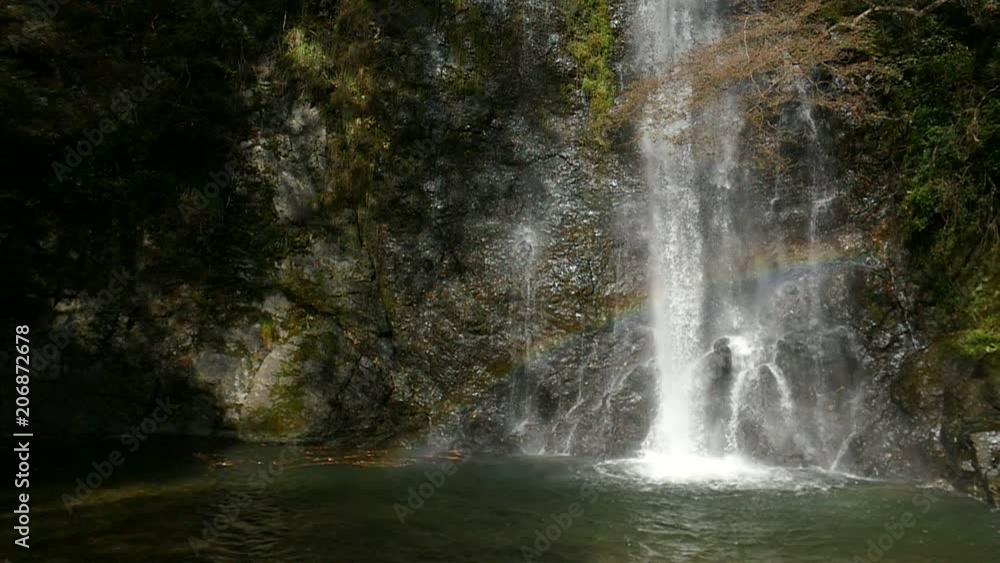 Slow motion shot of Mino (or Minoo, Mino-o, Minoh) waterfall with rainbow in Osaka, Kansai region, Japan. Slow motion shot of Mino (or Minoo, Mino-o, Minoh) waterfall with rainbow in Osaka, Kansai region, Japan.