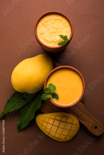Fototapeta Naklejka Na Ścianę i Meble -  Mango Lassi, Indian popular summer drink in a terracotta glass, selective focus