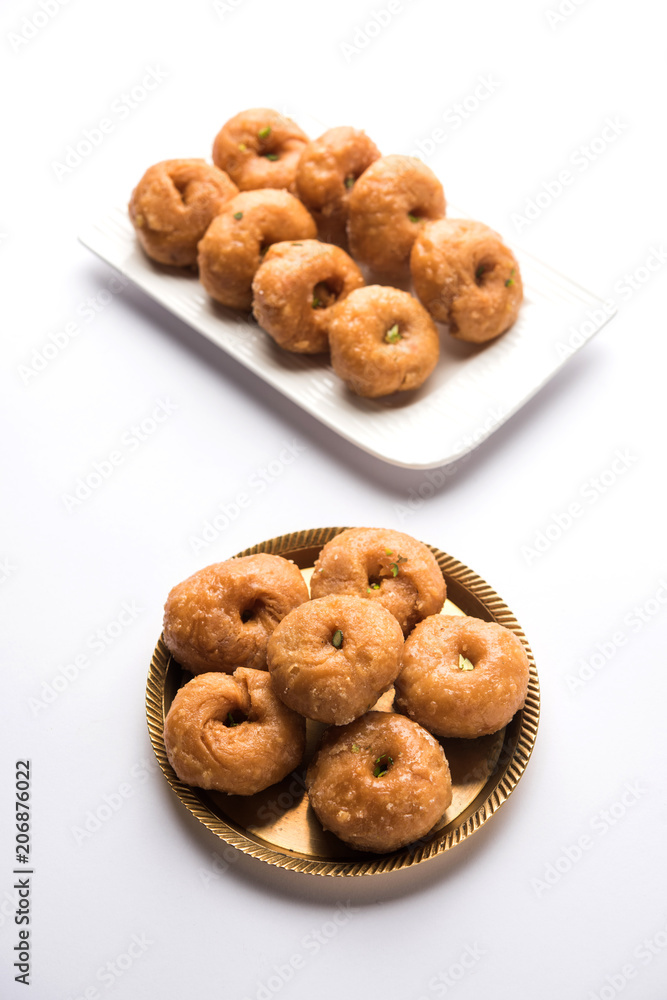 Balushahi sweet food served in a white or golden plate over moody background Balushahi sweet food served in a white or golden plate over moody background