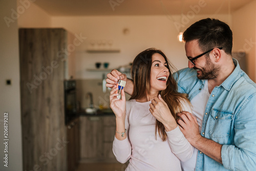 Tableau sur toile Young man surprising his wife or a girl with new a apartment.