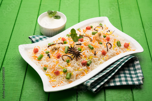 Indian Vegetable Pulav or Biryani made using Basmati Rice, served in a ceramic bowl. selective focus