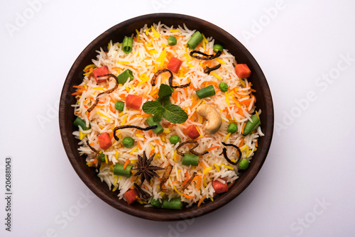 Photography Indian Vegetable Pulav or Biryani made using Basmati Rice, served in a ceramic bowl