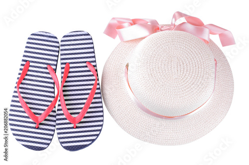 Summer hat with a pink ribbon and flip flops in blue and white stripes. Isolated photo