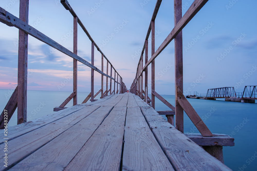 Swimming ladder from stainless steel for descent into sea water on pier. Silent bay ideal for children swim and play Swimming ladder from stainless steel for descent into sea water on pier. Silent bay ideal for children swim and play