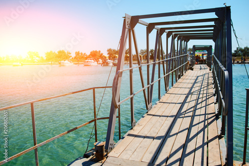 Swimming ladder from stainless steel for descent into sea water on pier. Silent bay ideal for children swim and play photo