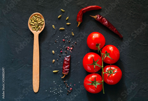 Wooden spoon with spices on dark background.Frame of organic food. The concept of vegetarian food and healthy diet,  copy space, closeup.