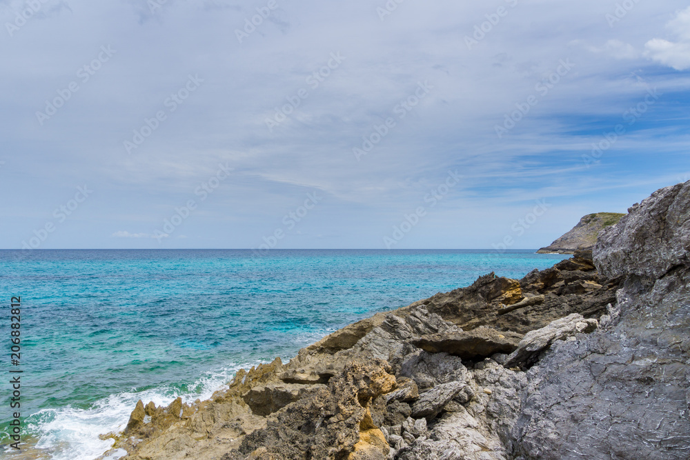 Mallorca, Rough rocky cliff line of island coast with blue sea water nature landscape Mallorca, Rough rocky cliff line of island coast with blue sea water nature landscape