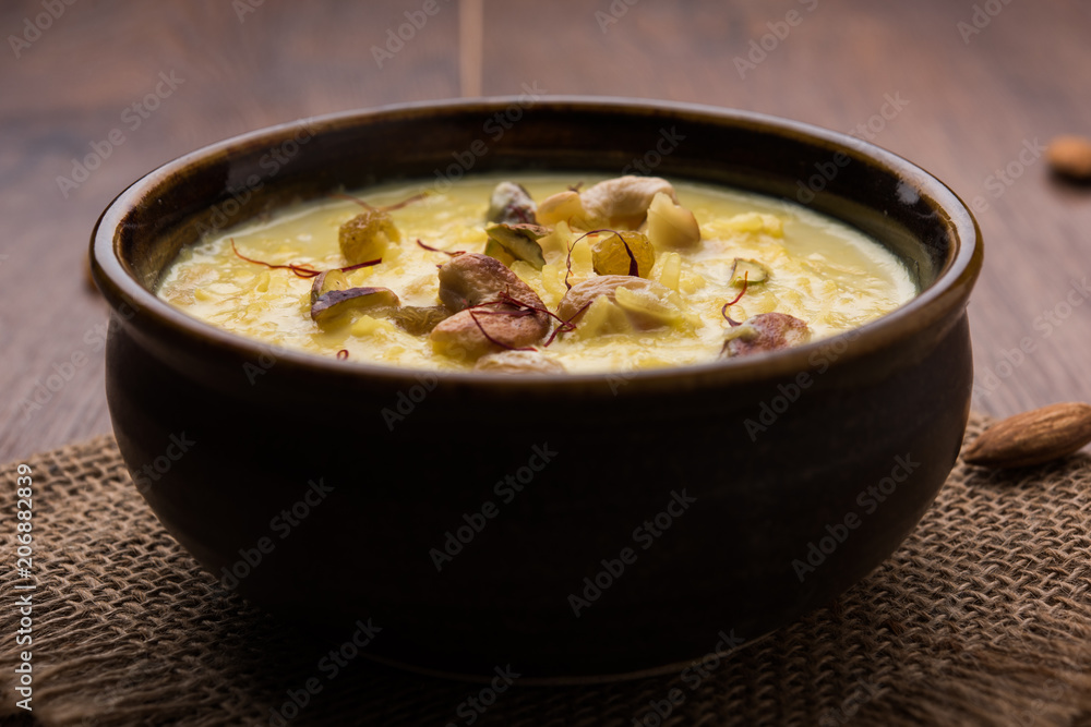 Rice pudding OR Kheer from India called also called Firnee. served in a bowl. Selective focus