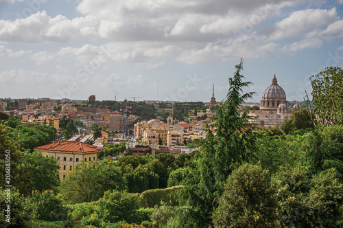 Overview of trees, cathedrals domes, monuments and roofs on a cloudy day at Rome, the incredible city of the Ancient Era, known as "The Eternal City". Located in the Lazio region, central Italy