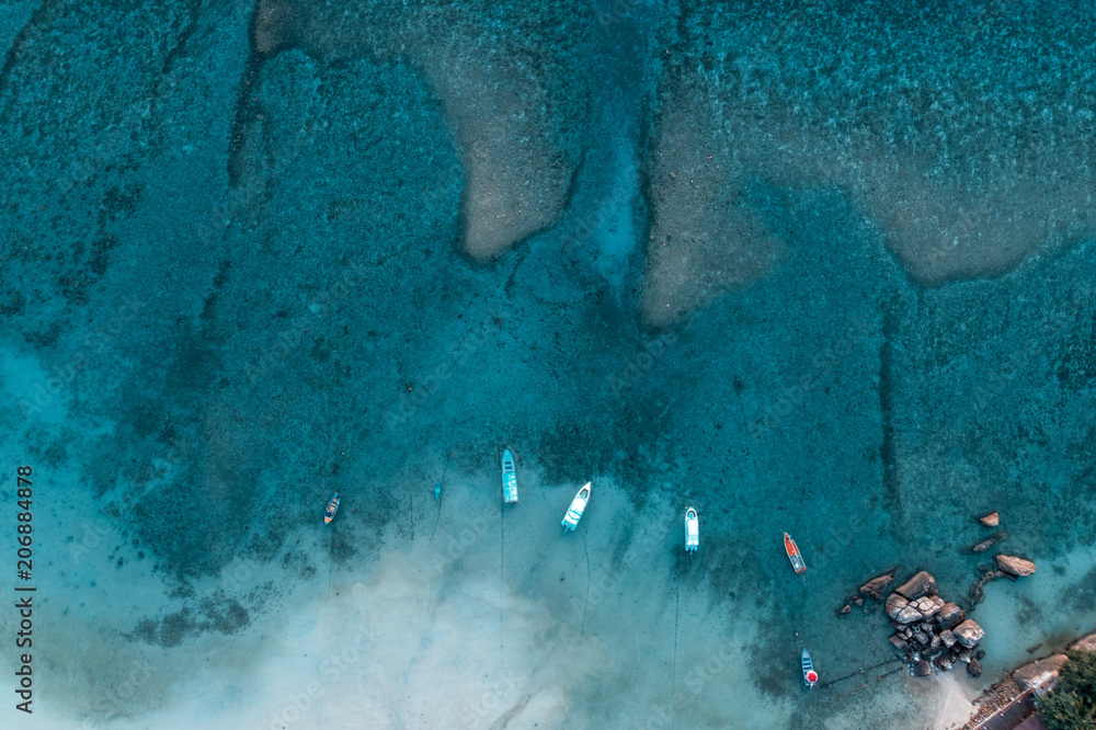 Aerial view over long tail boats with beautiful sea and beach, drone shot