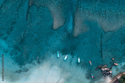 Obraz na płótnie Aerial view over long tail boats with beautiful sea and beach, drone shot w salonie