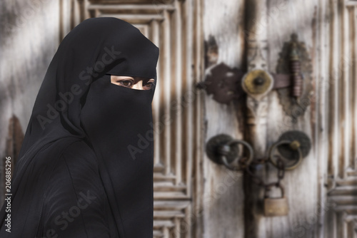 Portrait of a Middle Eastern woman wearing a black Niqab photo