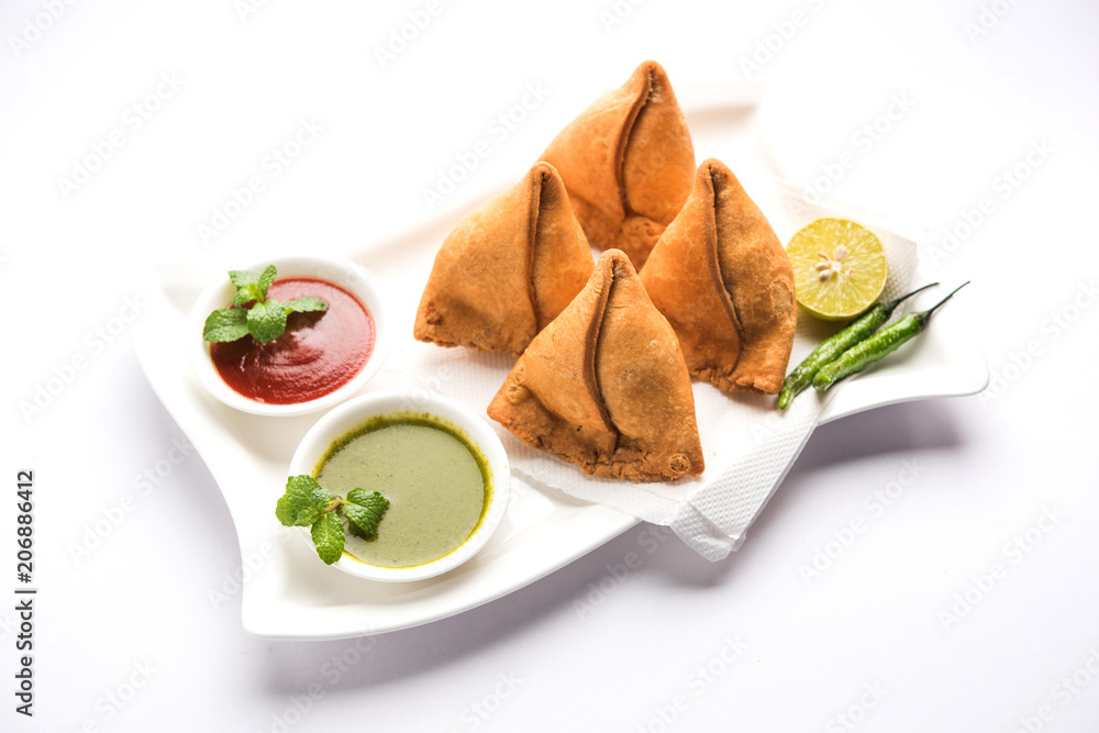 Samosa snack served with tomato ketchup and mint chutney Samosa snack served with tomato ketchup and mint chutney