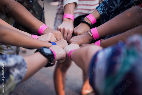 The hands of a group of people who combine forces. Prior to the activity. subject is blurred and soft focus.