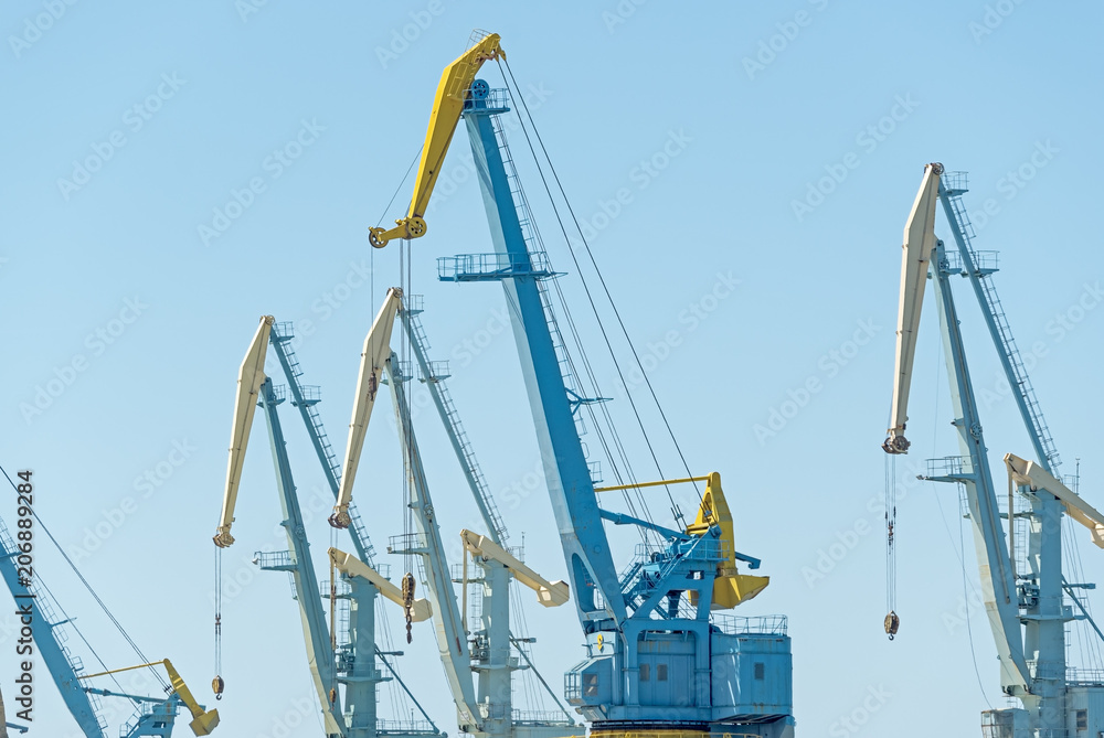 old port cranes on background sky
