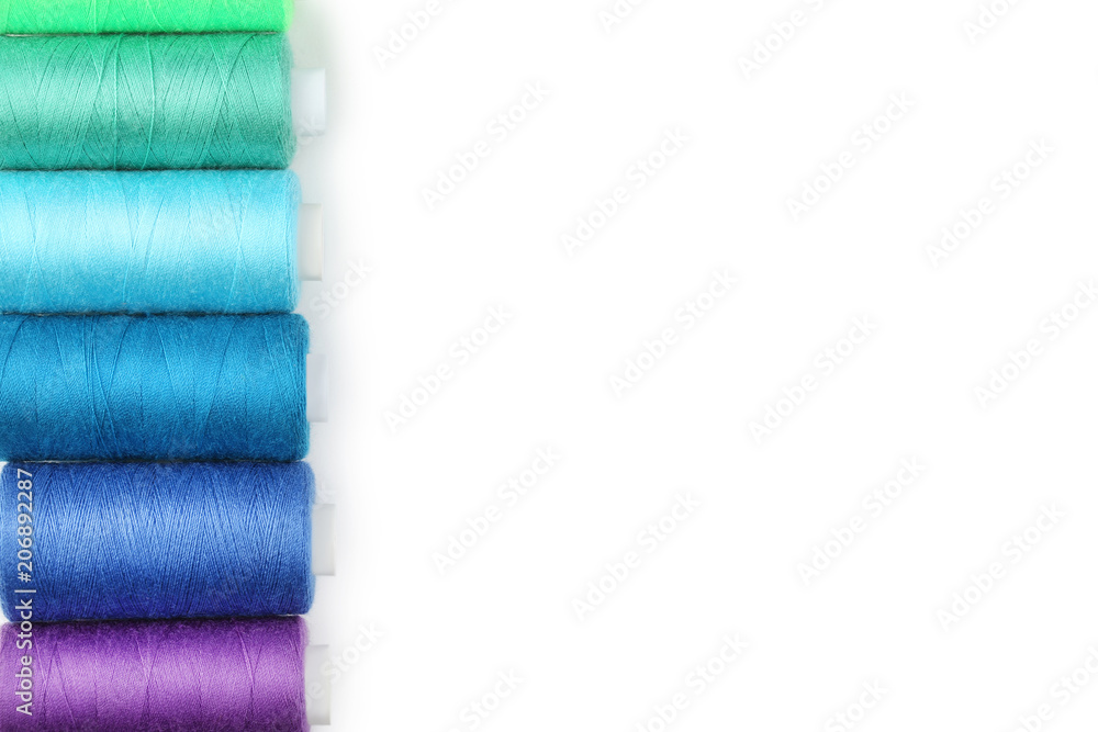 Colourful thread spools on white background Colourful thread spools on white background