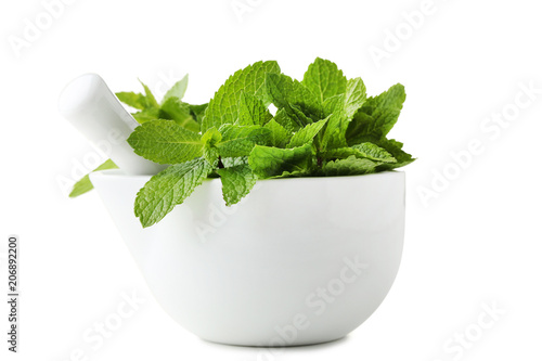 Fresh mint in mortar isolated on white