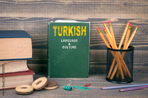 Turkish language and culture concept. Book on a wooden background photo