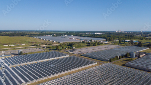 Aerial agricultural view of lettuce production field and greenhouse