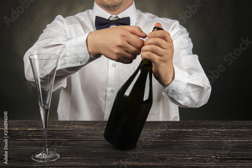 Cropped image of bartender pouring champagne into glass at bar counter photo