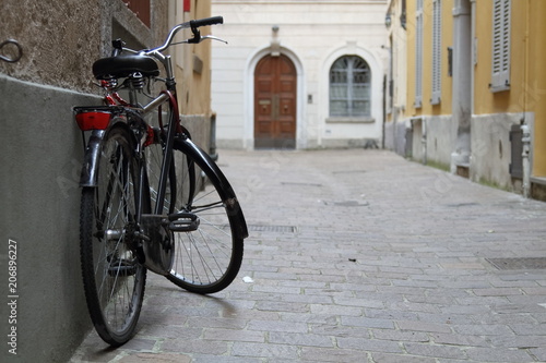 bicicletta nera vintage appoggiata al muto città antica