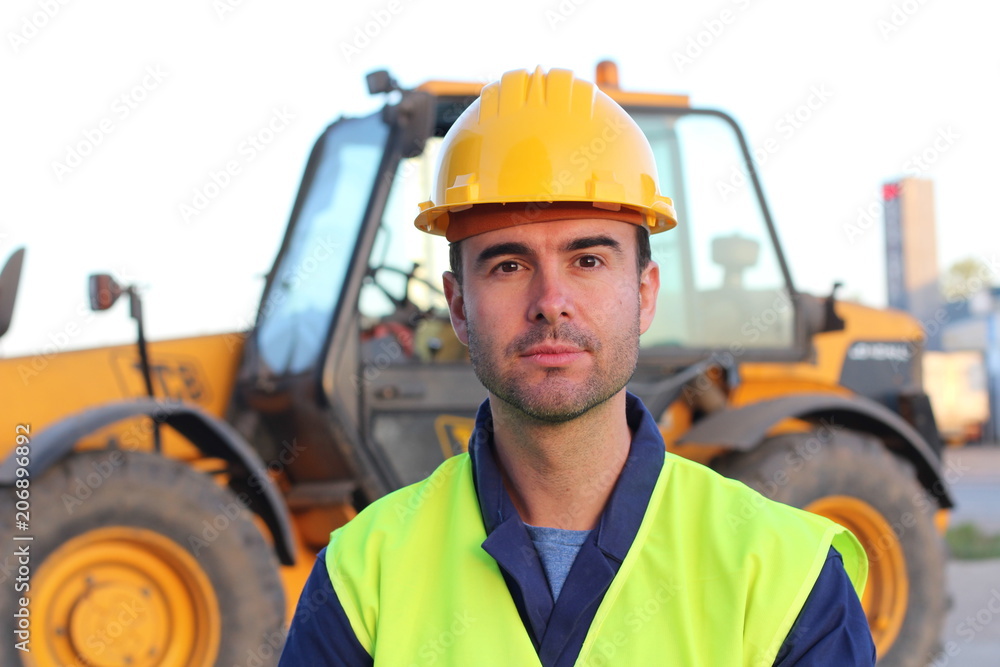 Construction driver with excavator on the background Construction driver with excavator on the background