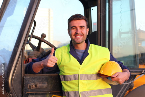 Construction driver with excavator on the background