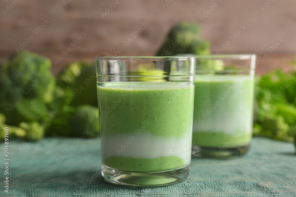 Glasses with healthy detox smoothie and ingredients on table Glasses with healthy detox smoothie and ingredients on table