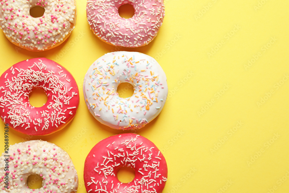 Delicious glazed doughnuts on color background, top view Delicious glazed doughnuts on color background, top view