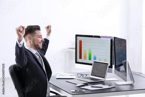 Male broker working in offi...