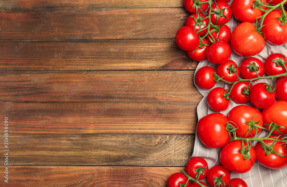 Flat lay composition with ripe tomatoes on wooden background Flat lay composition with ripe tomatoes on wooden background