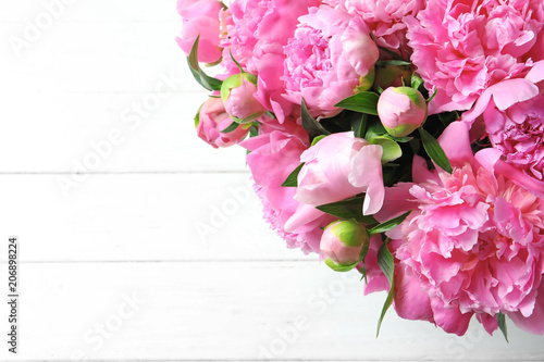 Beautiful fragrant peony flowers on light background