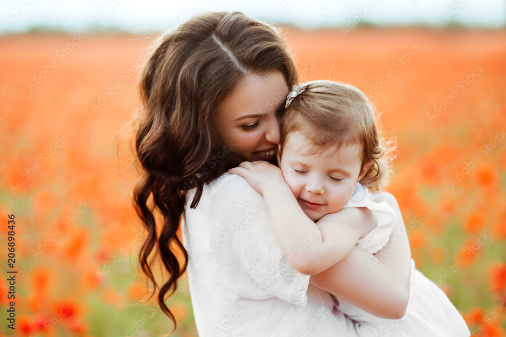 mother and daughter playing in flower field mother and daughter playing in flower field